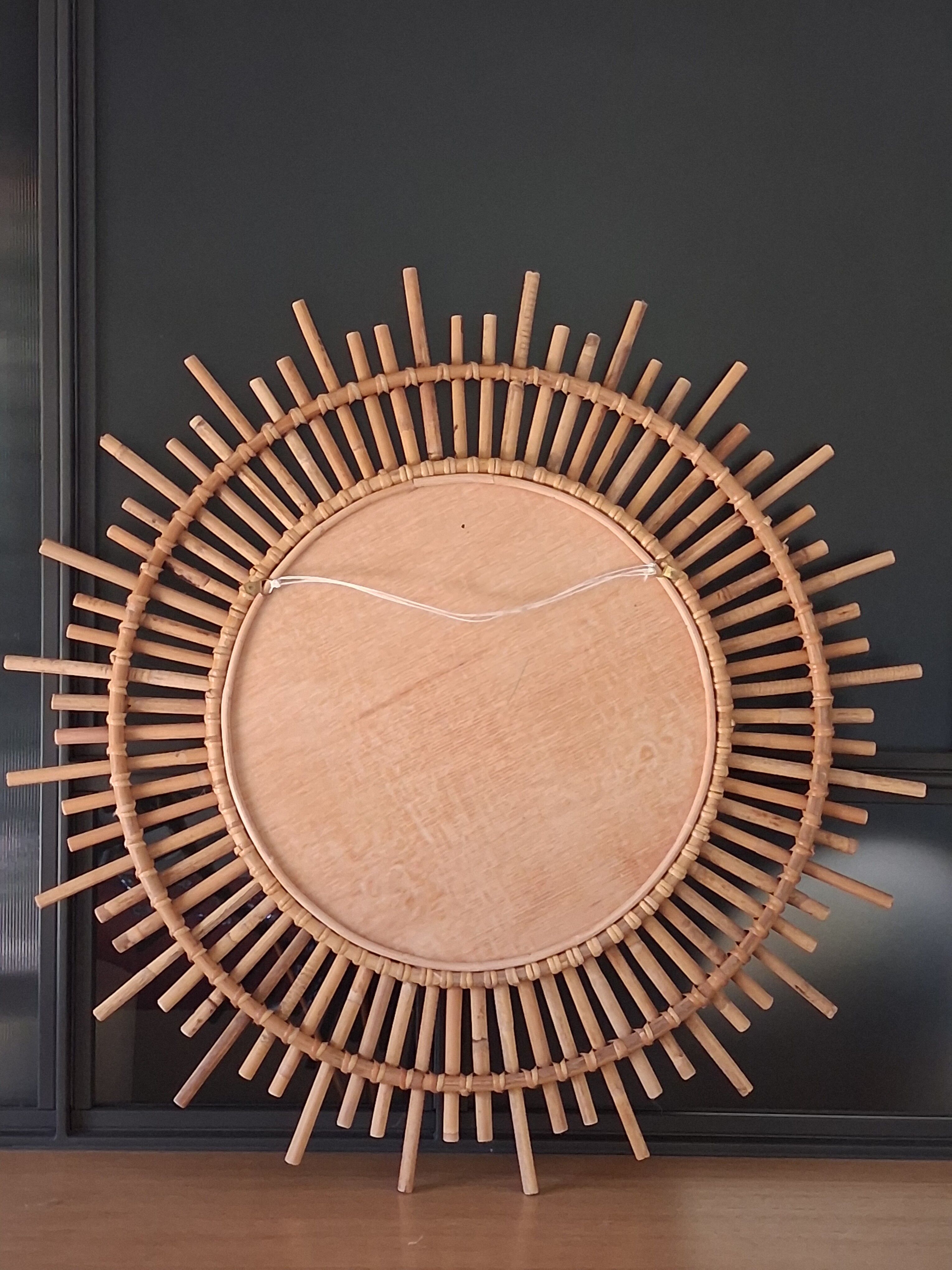 Very large sun mirror in rattan.