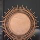 Very large sun mirror in rattan.