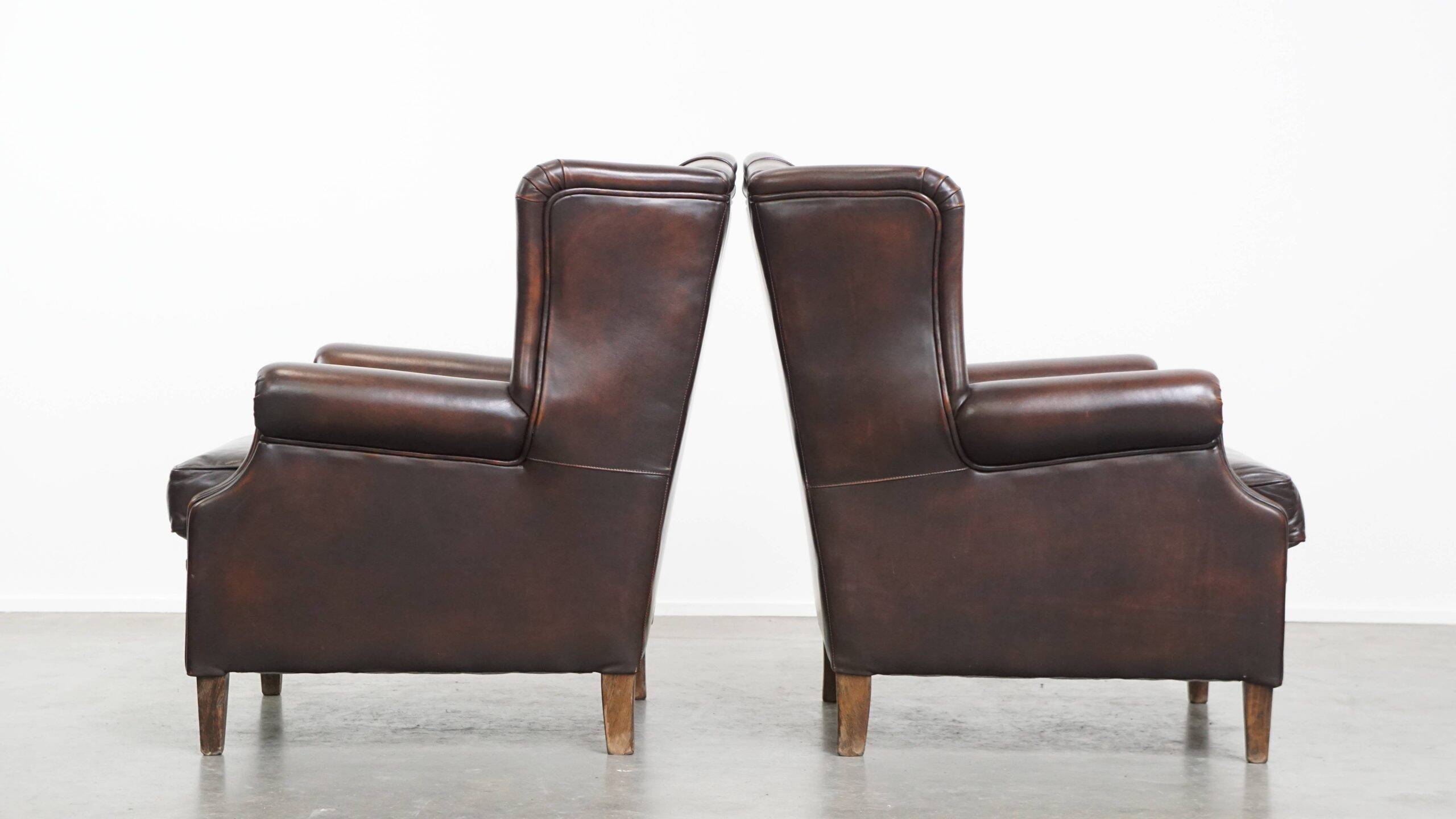 Comfortable and very beautiful set of 2 cow leather wingback armchairs in English style