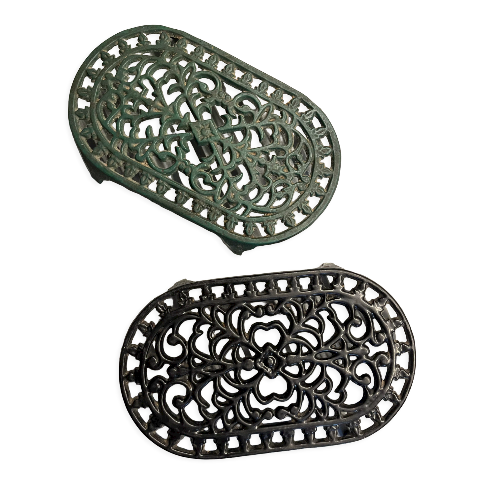 Duo of antique cast iron table mats
