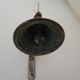 Cloche de porte en fonte
