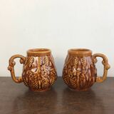 Set of 2 vintage caramel-colored slip mugs with flower pattern