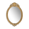 Miroir ovale 19ème en bois doré avec cimier coquille