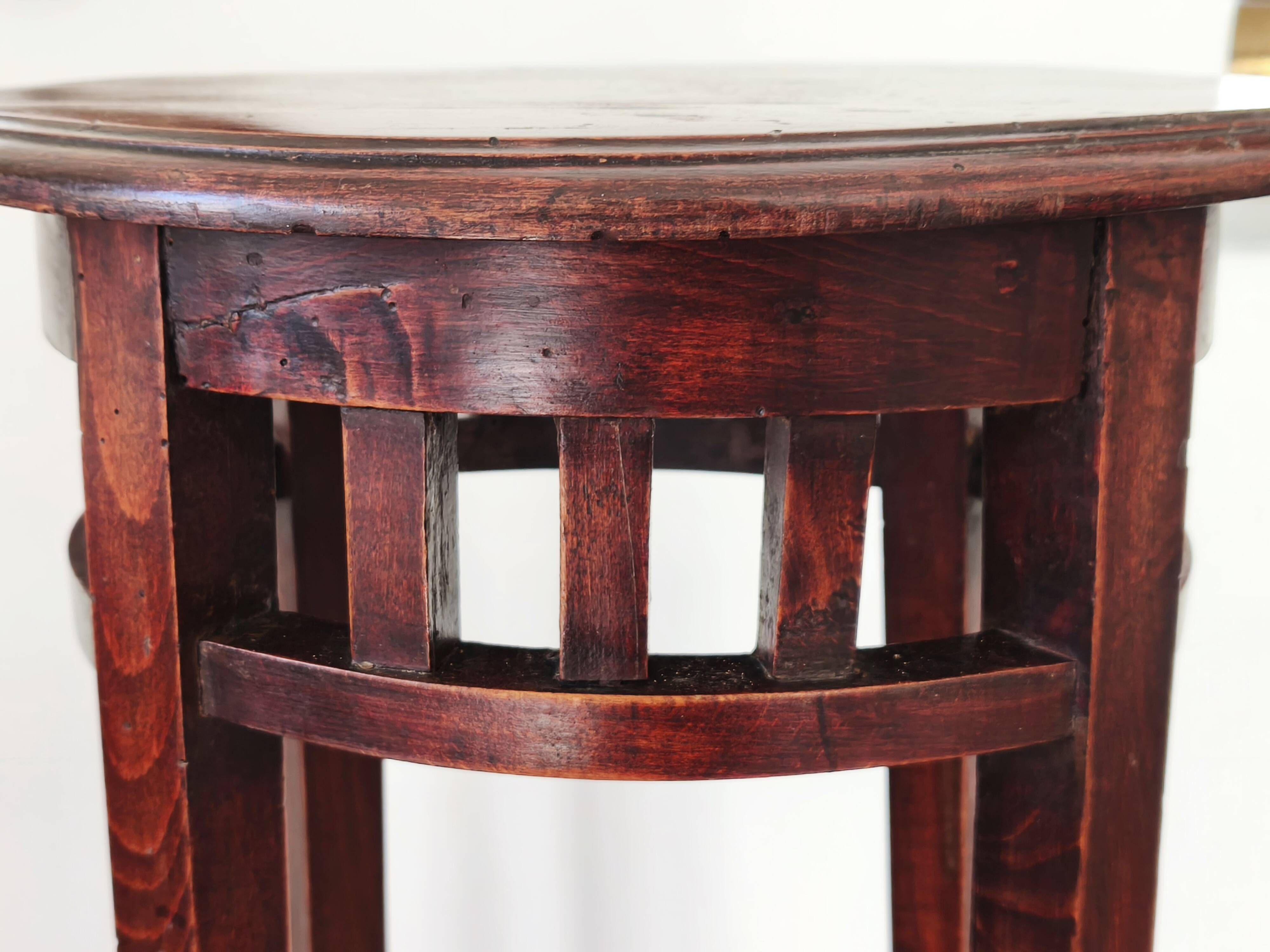 Antique high wooden pedestal with mahogany patina, circa 1900-1925.