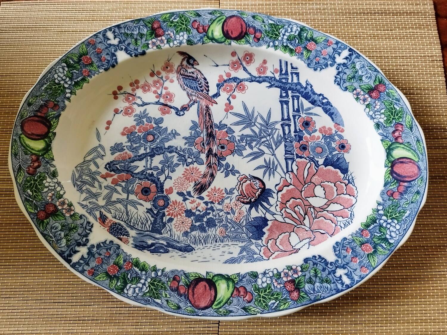 Oval Japanese plate with peacock decoration.