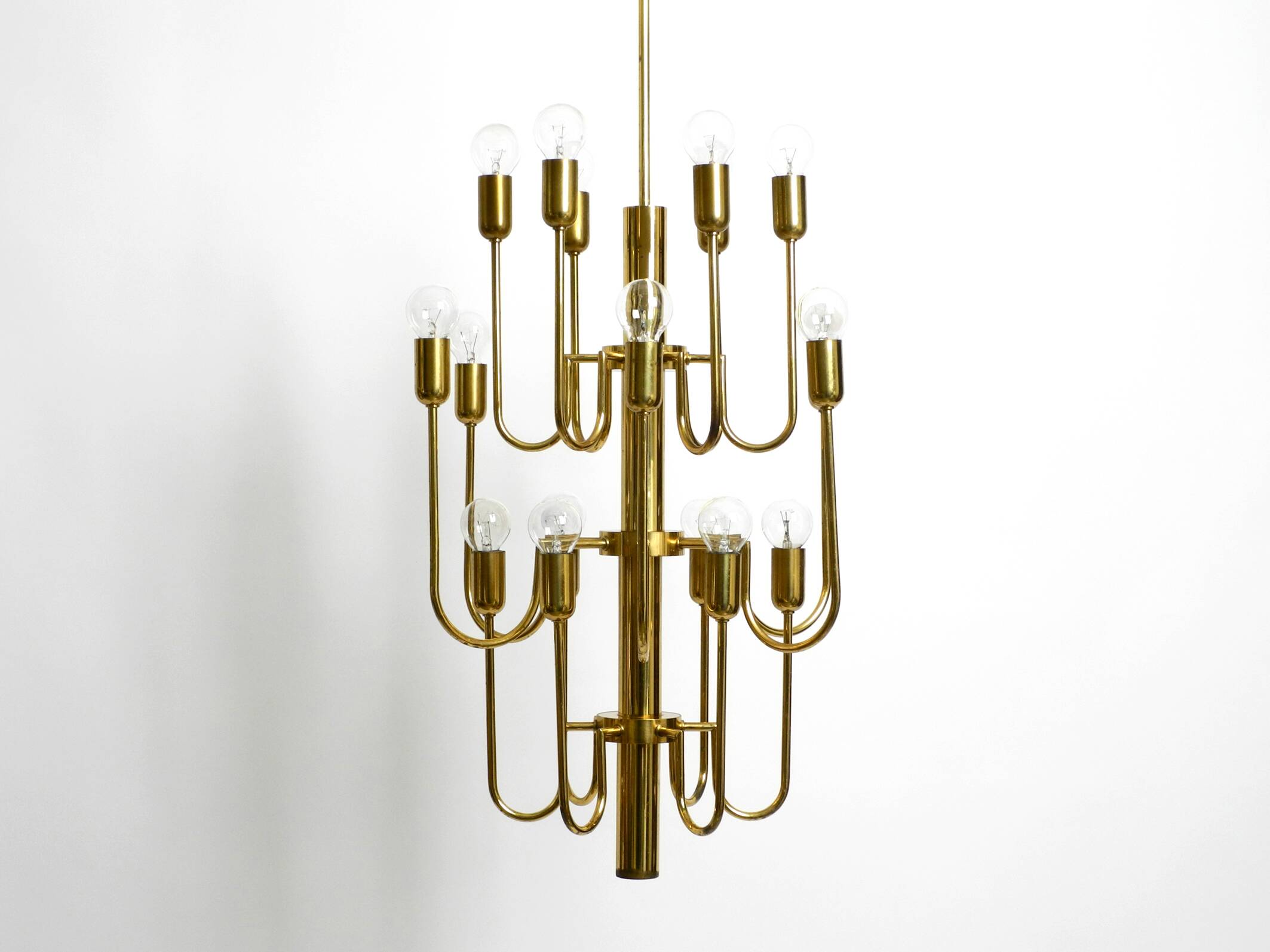 Three staged 18 arm Mid Century brass chandelier with a long brass rod