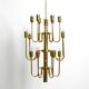 Three staged 18 arm Mid Century brass chandelier with a long brass rod