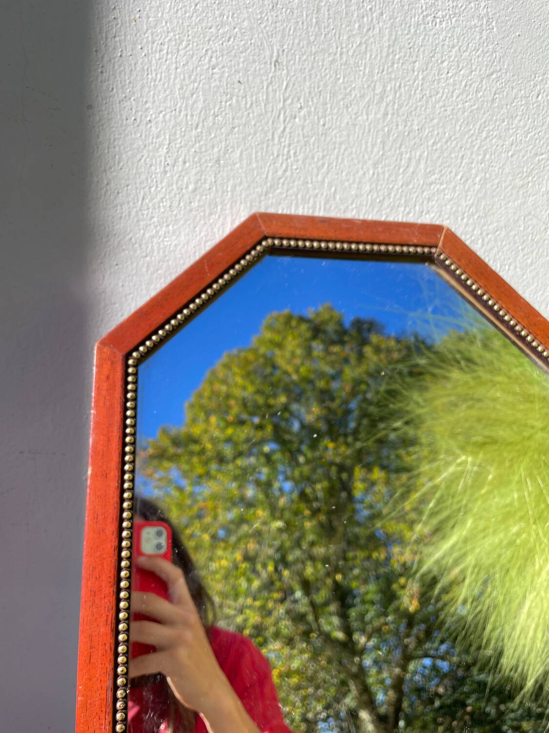 Octagonal beaded wooden mirror