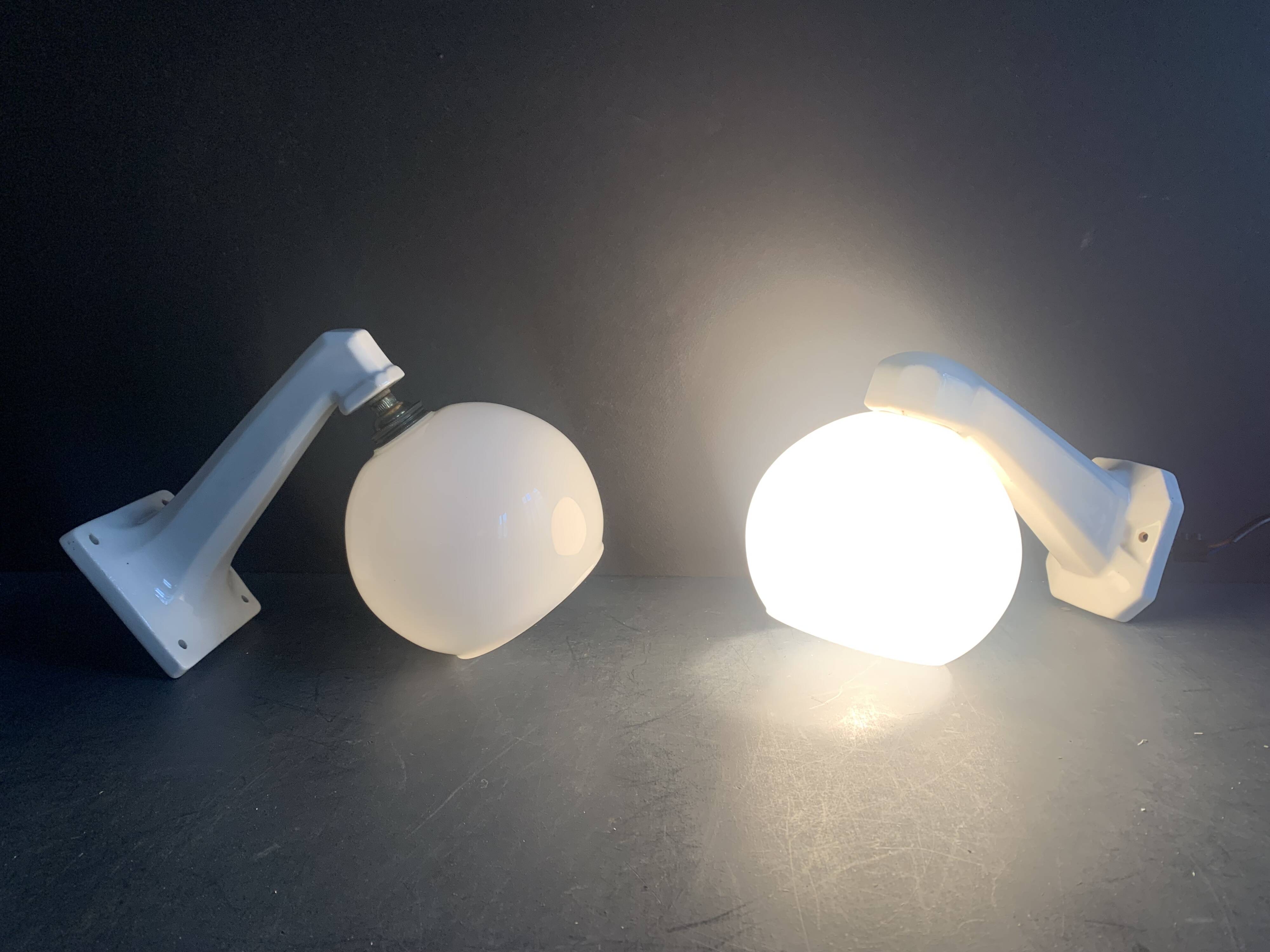 Pair of Art Deco porcelain wall lights with white Opaline globes, 1920
