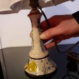 Ceramic table lamp with fish and plant decor and its lampshade