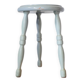 Antique tripod stool made of solid wood in blue.