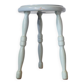 Antique tripod stool made of solid wood in blue.