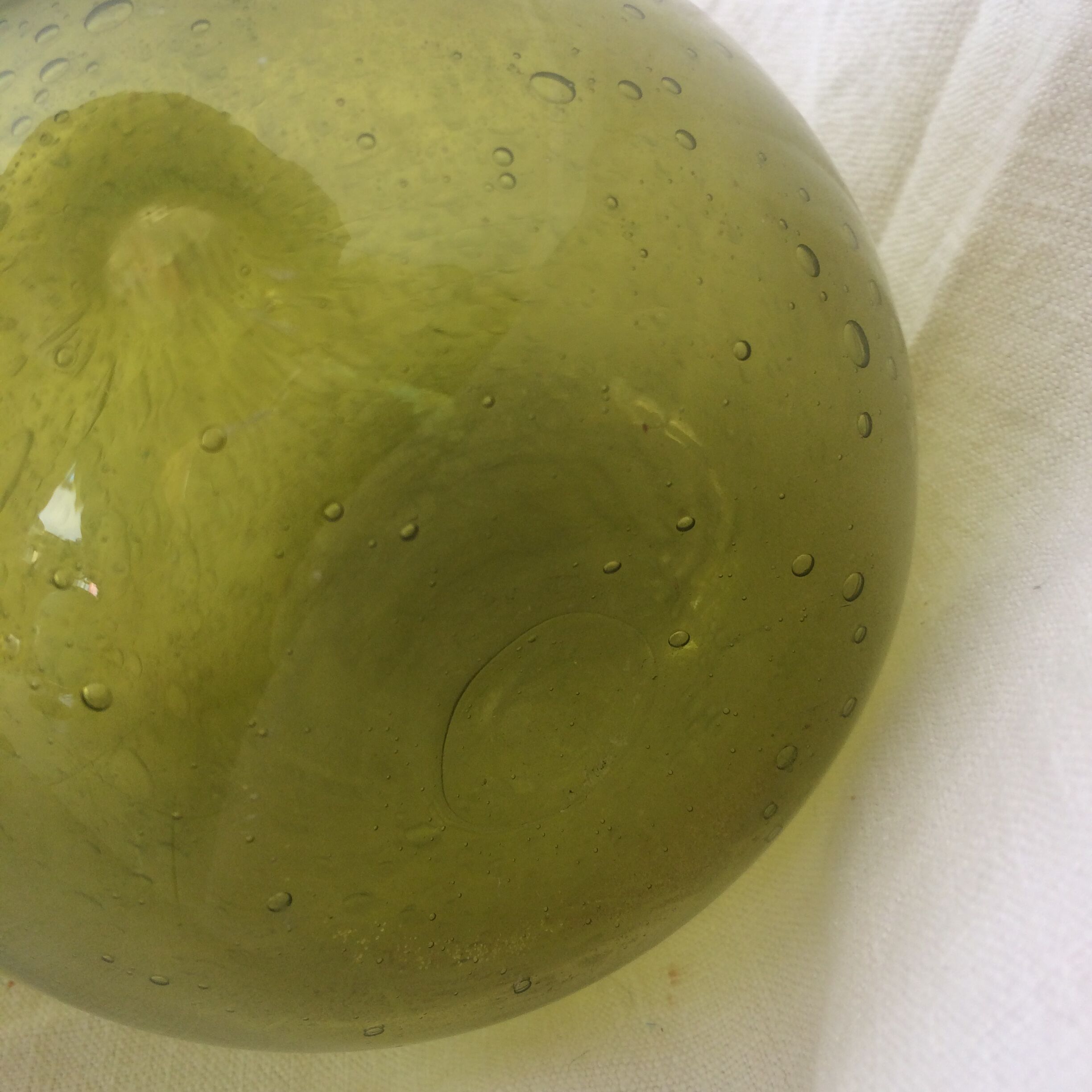 Green transparent glass bottle. Long-beaked biot.