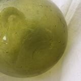 Green transparent glass bottle. Long-beaked biot.