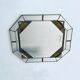 Old octagonal beveled mirror with parcloses