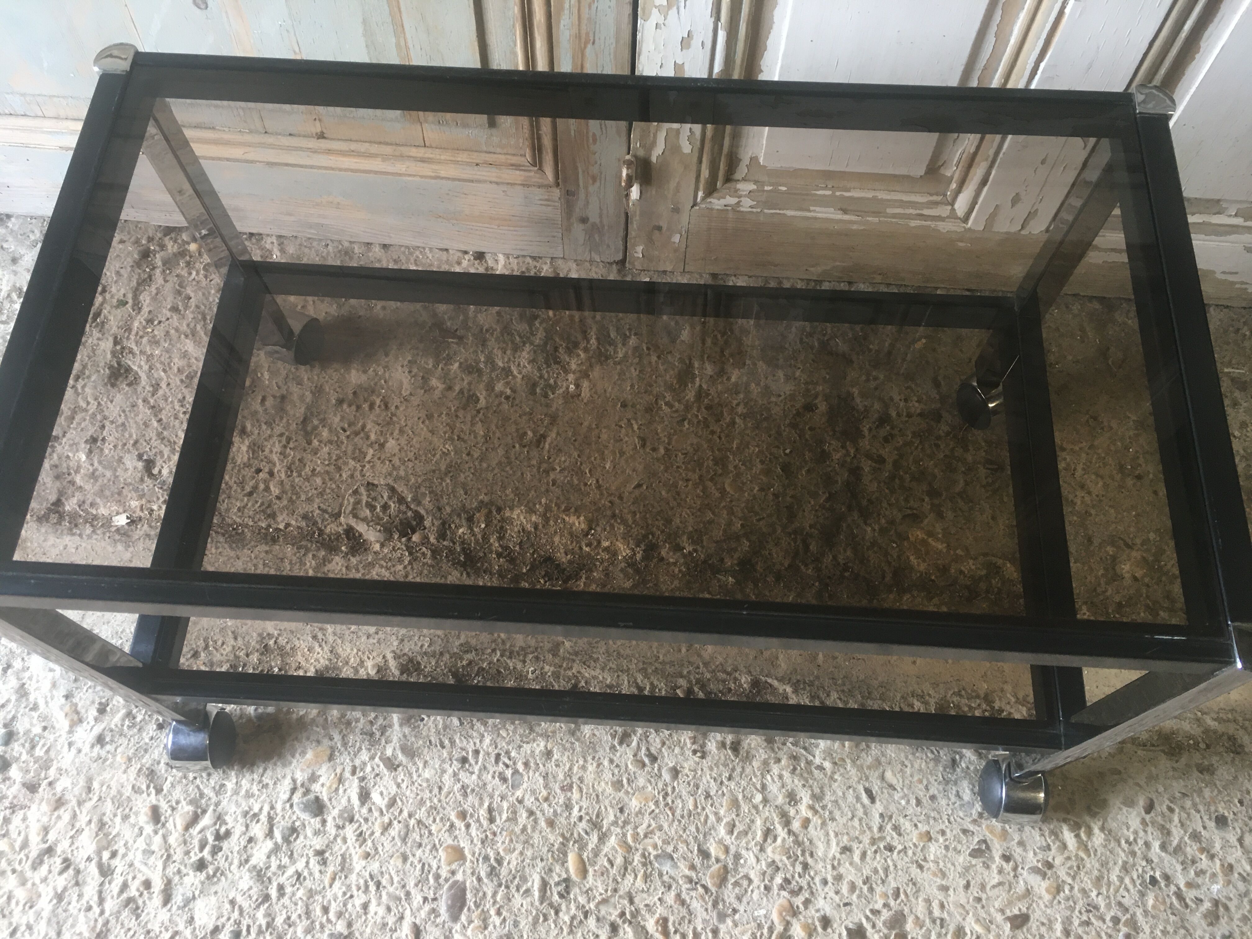 Metal coffee table with smoked glass.