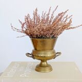 Vintage brass cache-pot on a stand with handles, classic decor.