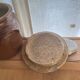 Ancient ceramic salt cellar and its lid.