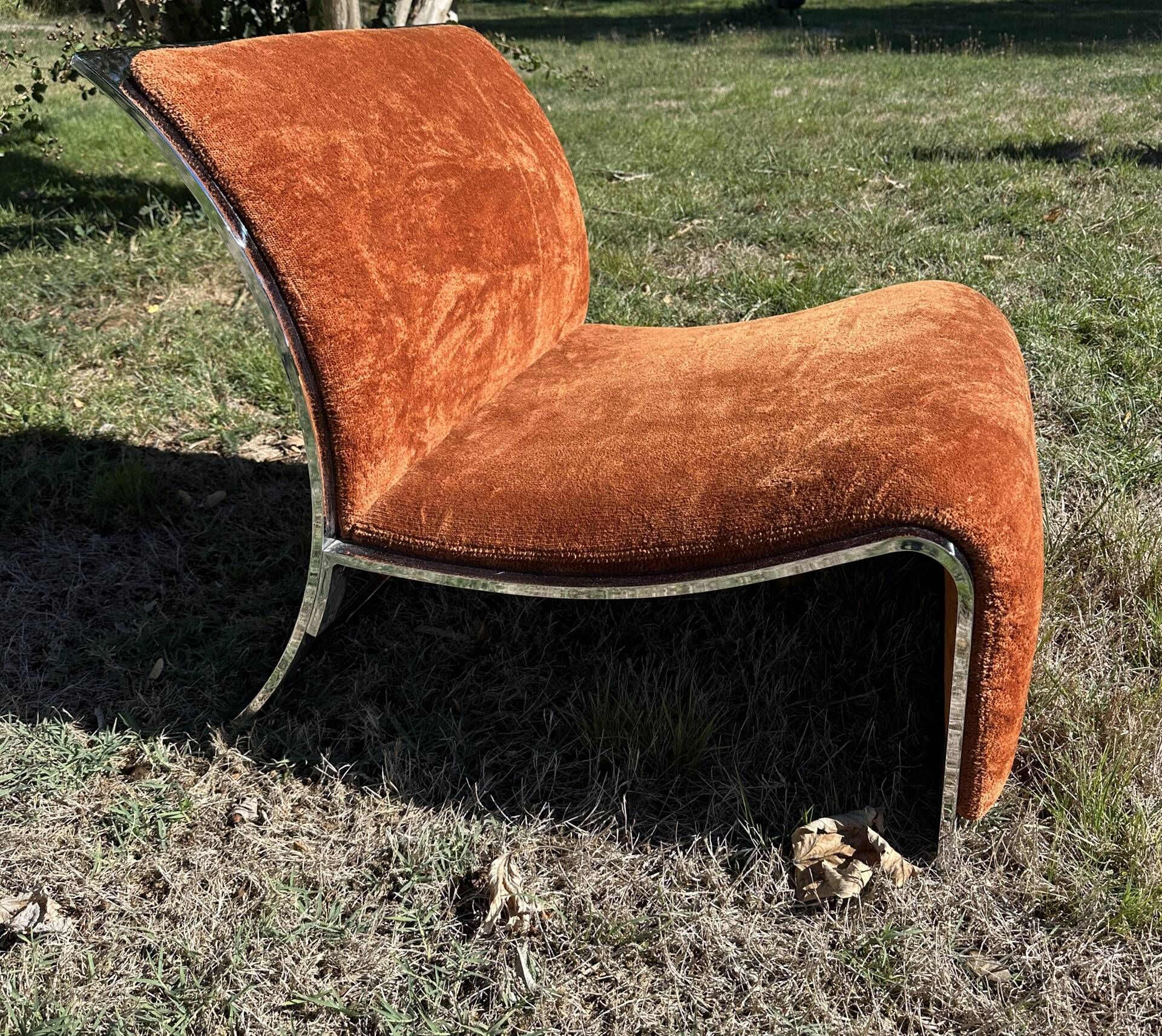Chrome steel armchair and orange fabric by Vittorio Introini