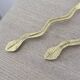 Gold metal snake salad serving set