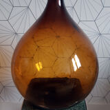 Great old demijohn in amber glass
