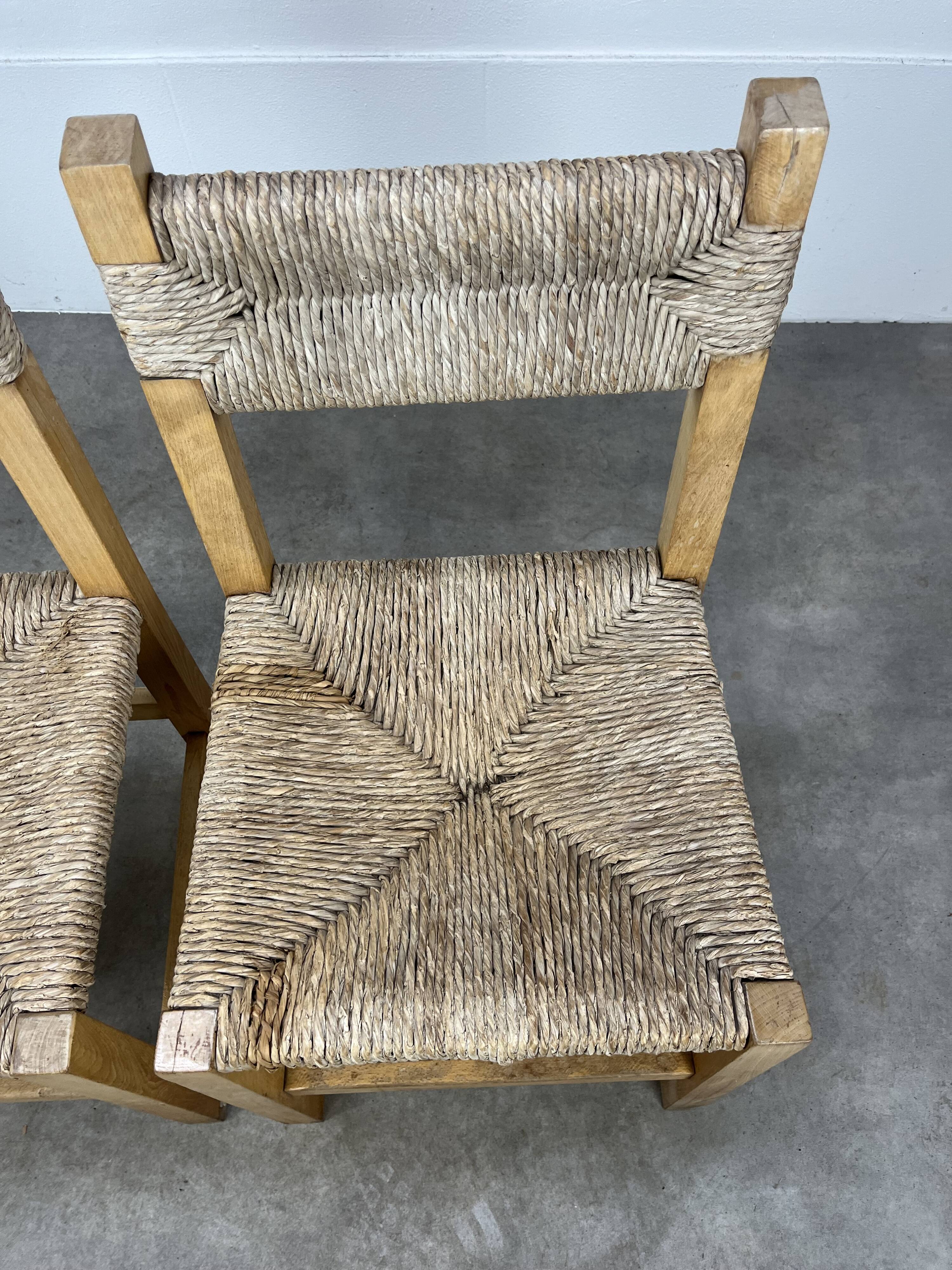 2 straw and wood chairs in brutalist style