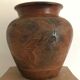 Vase or pot in brown terracotta with artistic decoration of fish.