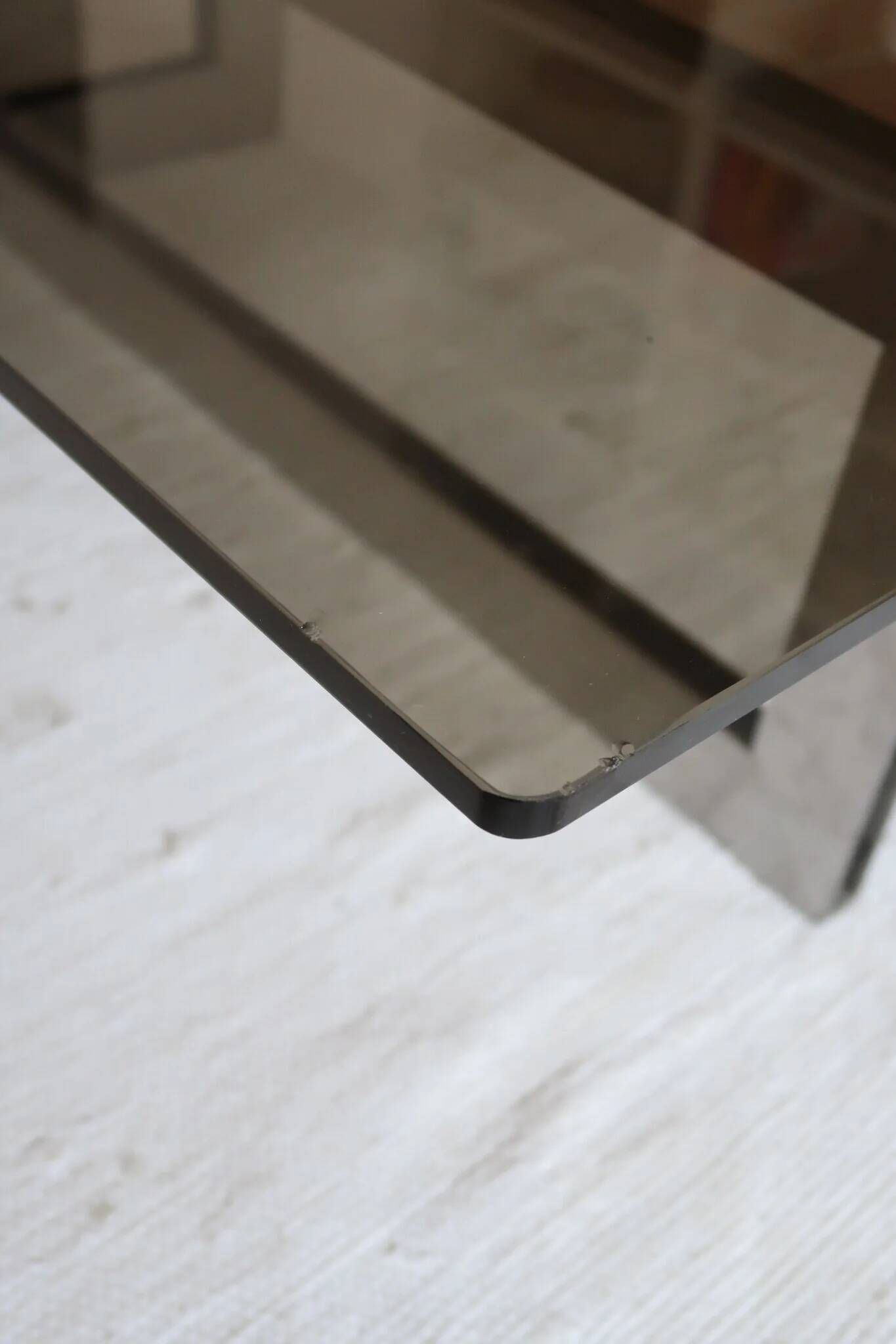 Smoked glass coffee table, brushed stainless steel base, 1970s.