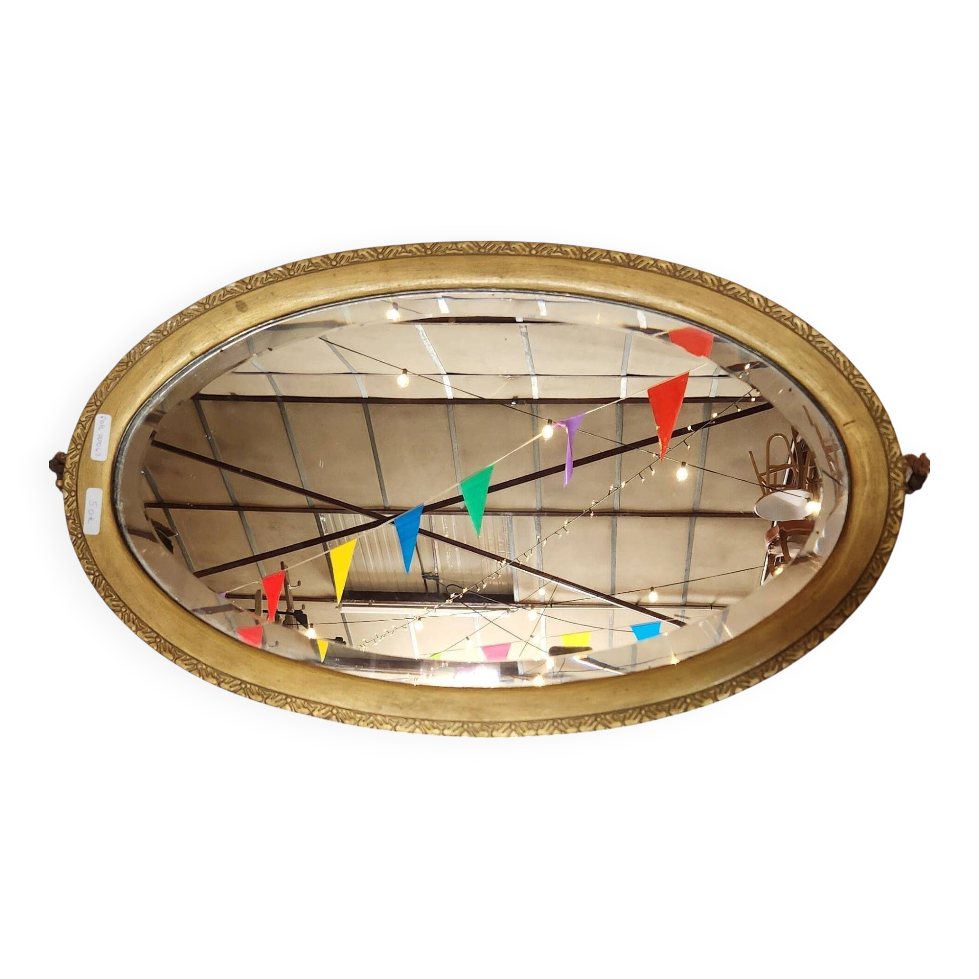 Antique oval mirror with a gilded frame, bevelled glass.