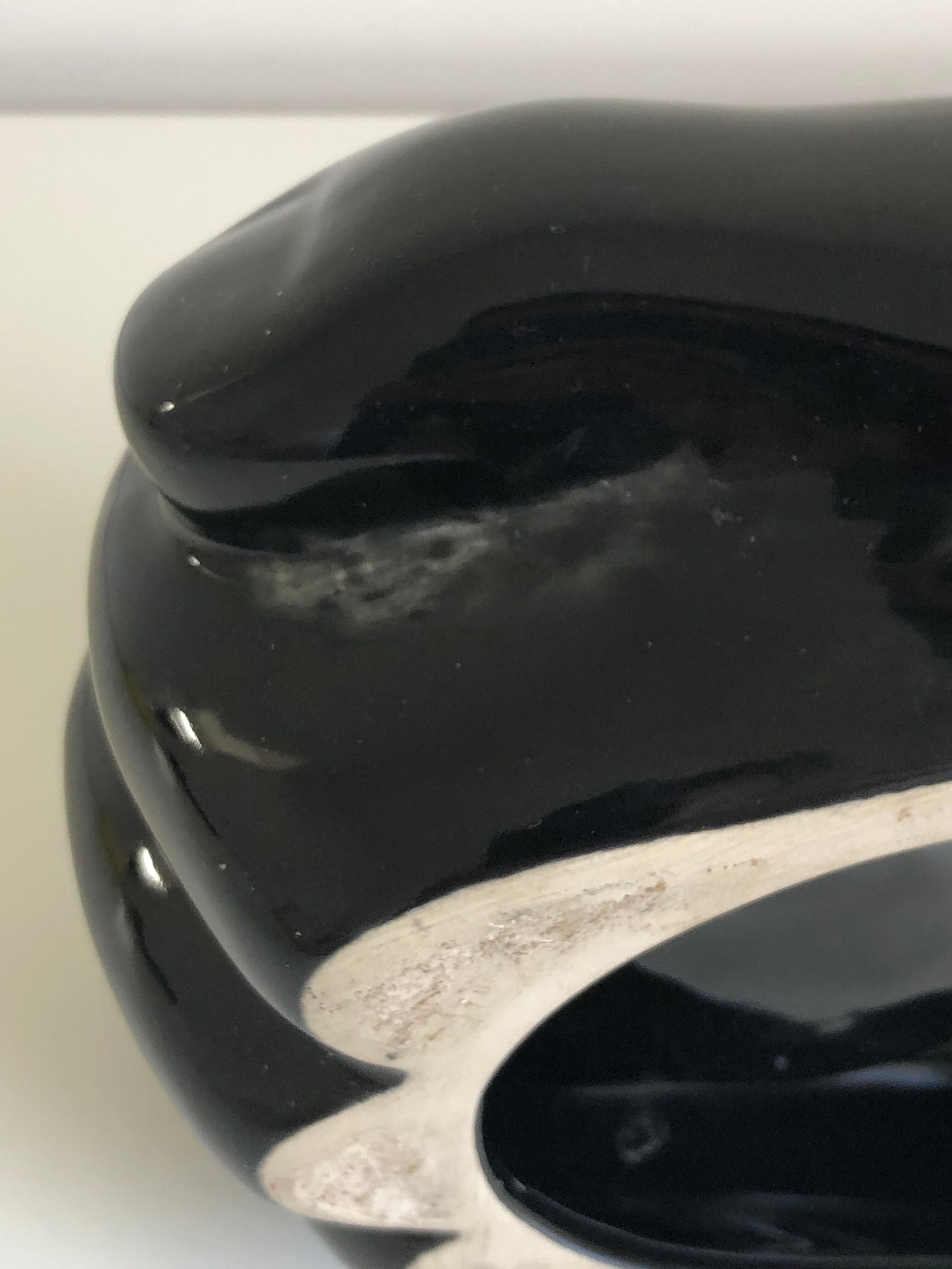 Empty black enamelled hand-shaped ceramic pocket, 1970