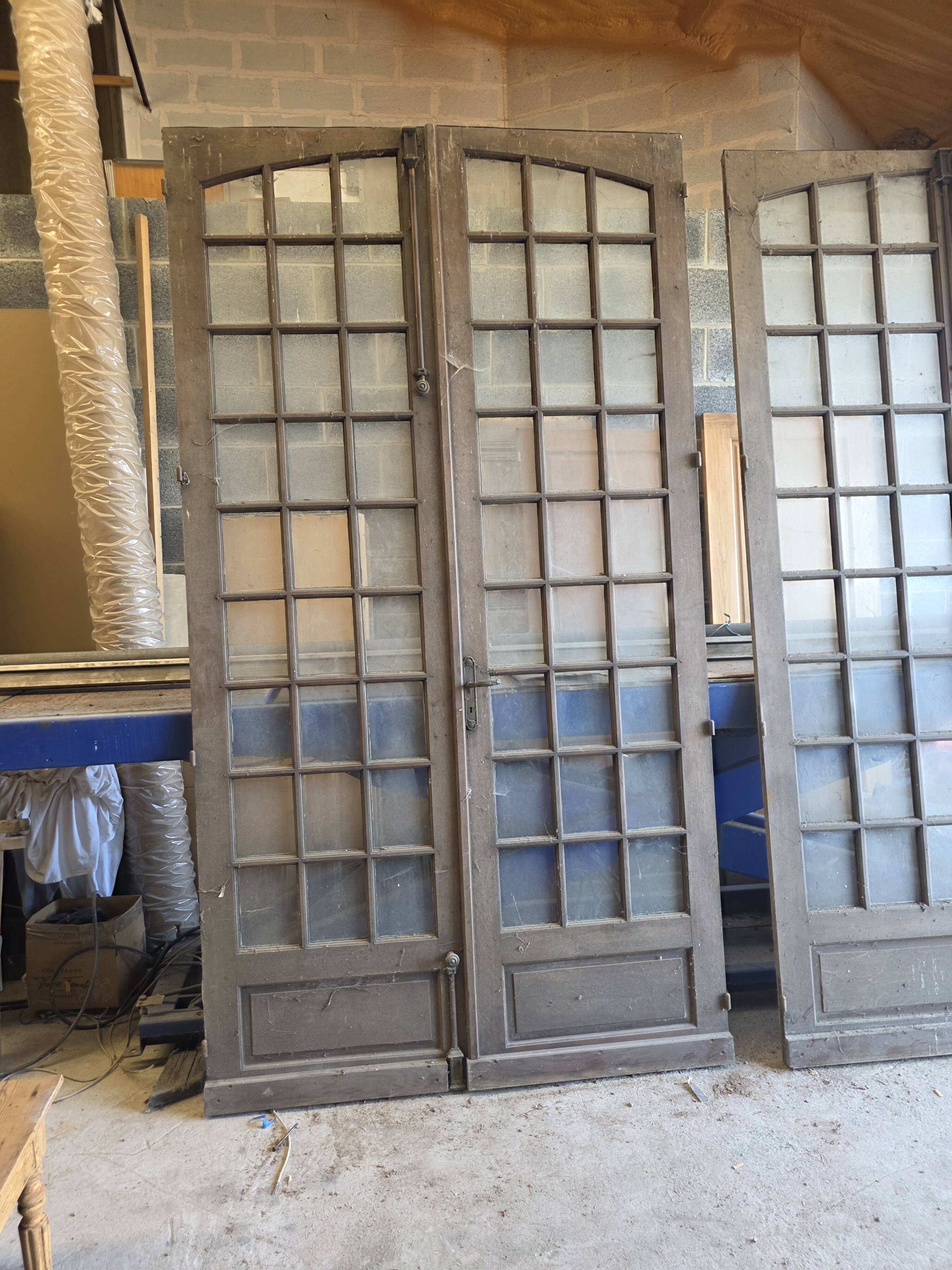 Two pairs of solid oak doors with small panes.