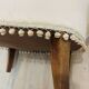 Pale pink upholstered armchair with wooden legs.