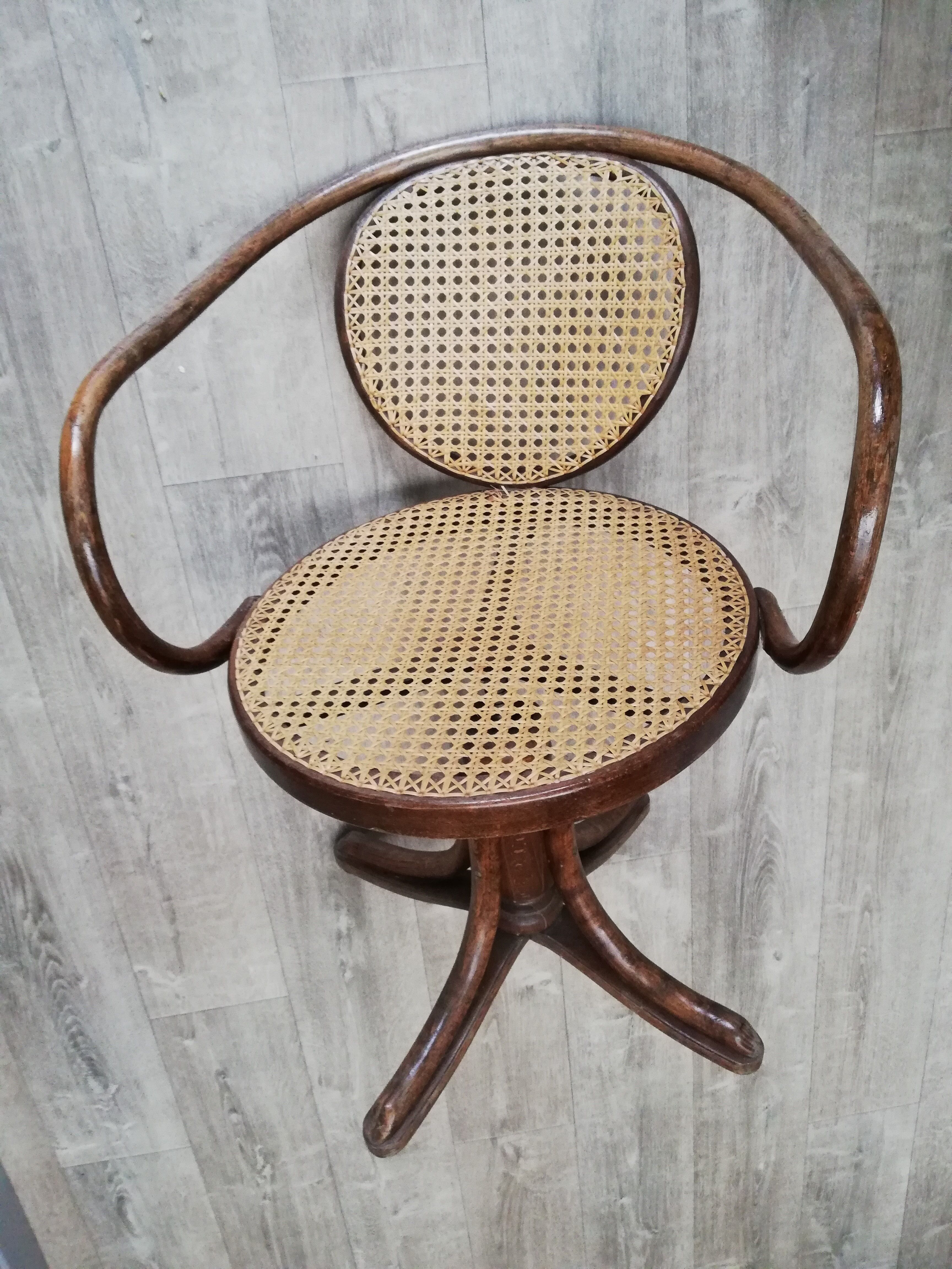 Office chair with curved wood swivel screw and Thonet cannage