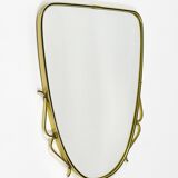 Elegant wall mirror in brass and black from the mid-century, Italy, 1950s.