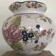 Round earthenware vase with polychrome floral motifs, signed