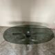 Table basse années 70 pied tulipe aluminium et verre fumé