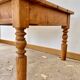 Antique coffee table in solid elm with turned legs.