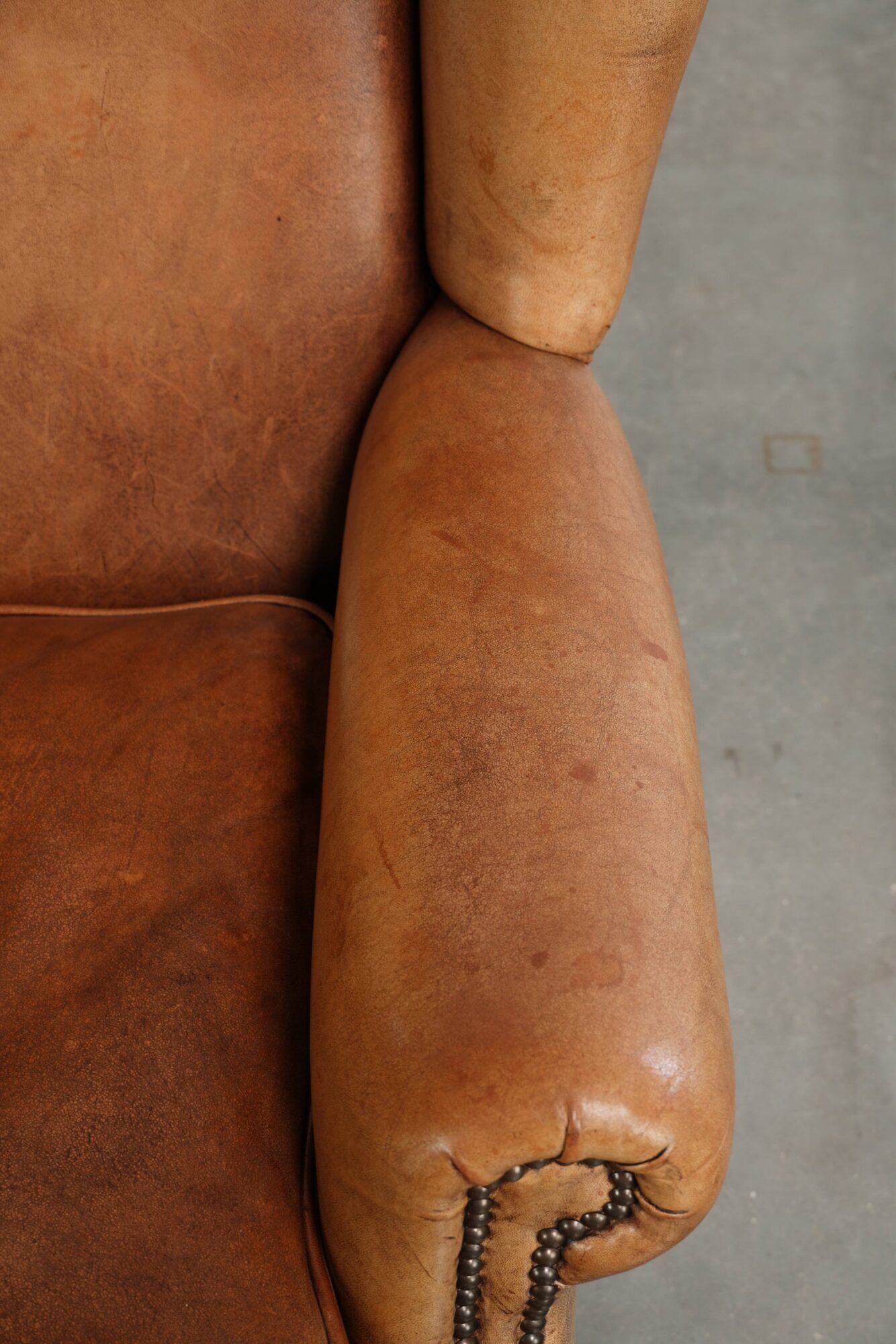Sheepskin wingback armchair in a light cognac colour in English style