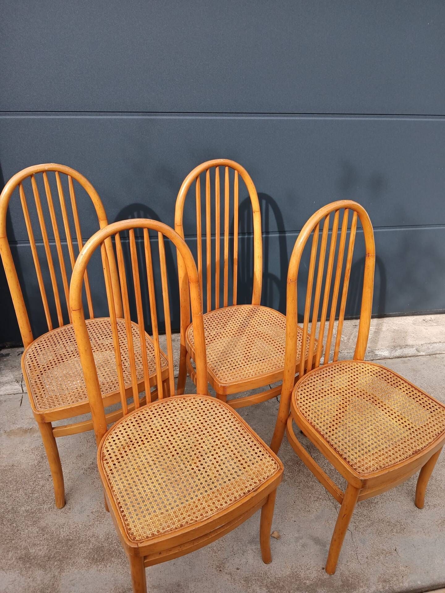 Set of 4 vintage Baumann chairs in honey wood and cane.