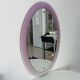Vintage oval plexiglass mirror from the 70s by Harvey Guzzini