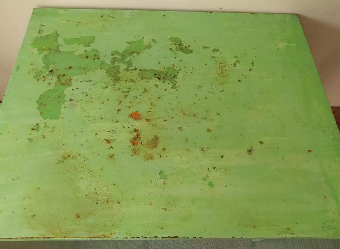 Green garden table in patinated metal