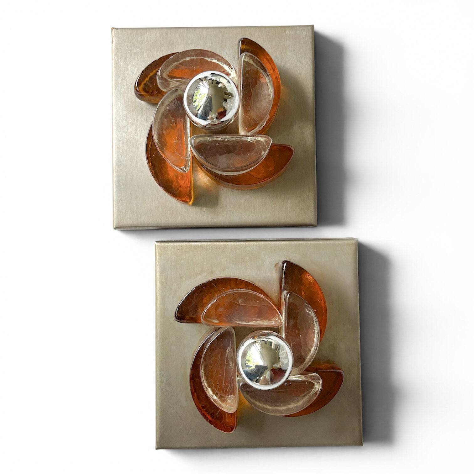 Pair of sculptural wall lights in moulded glass and metal