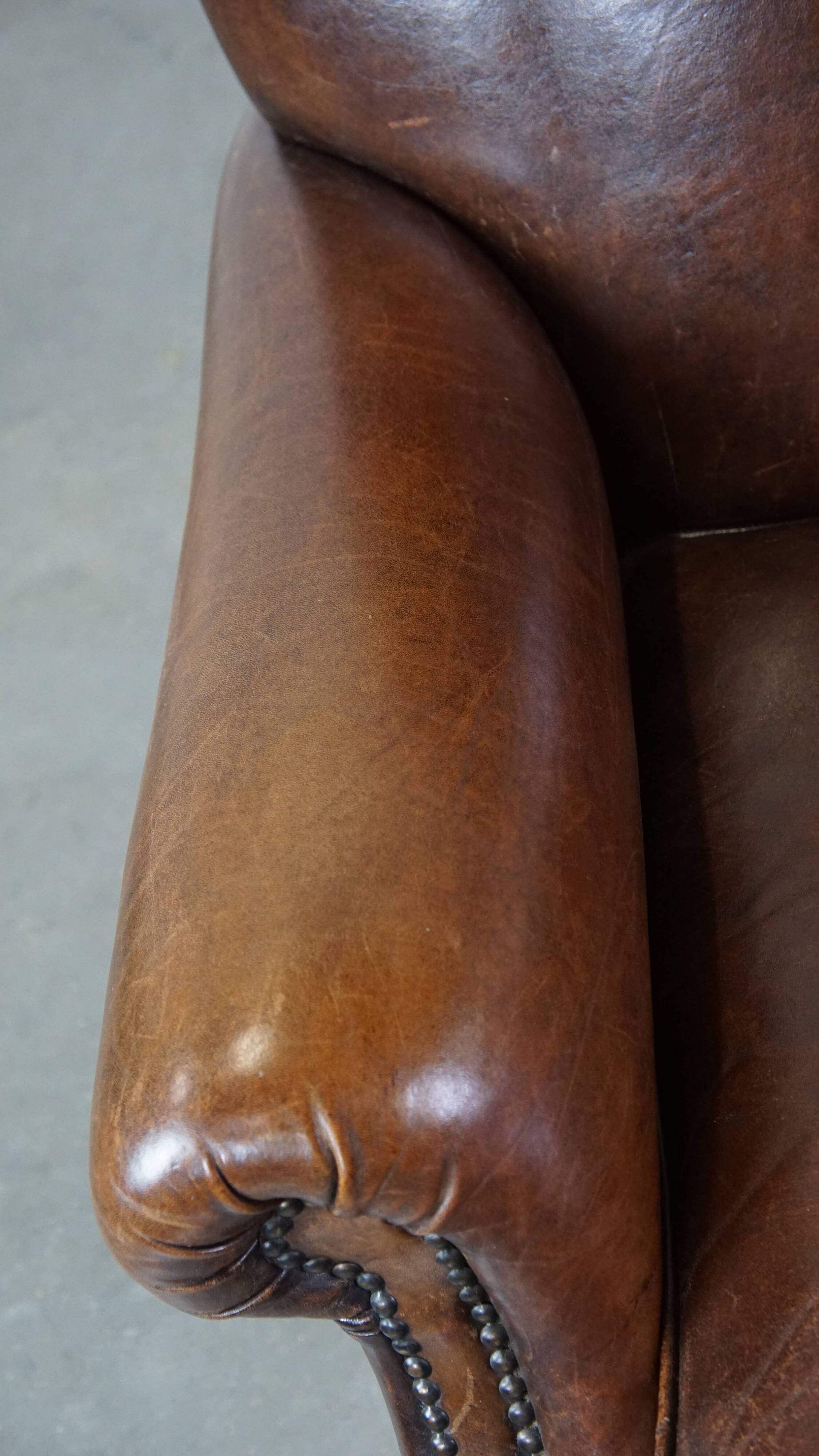 Sheep leather armchair on wheels