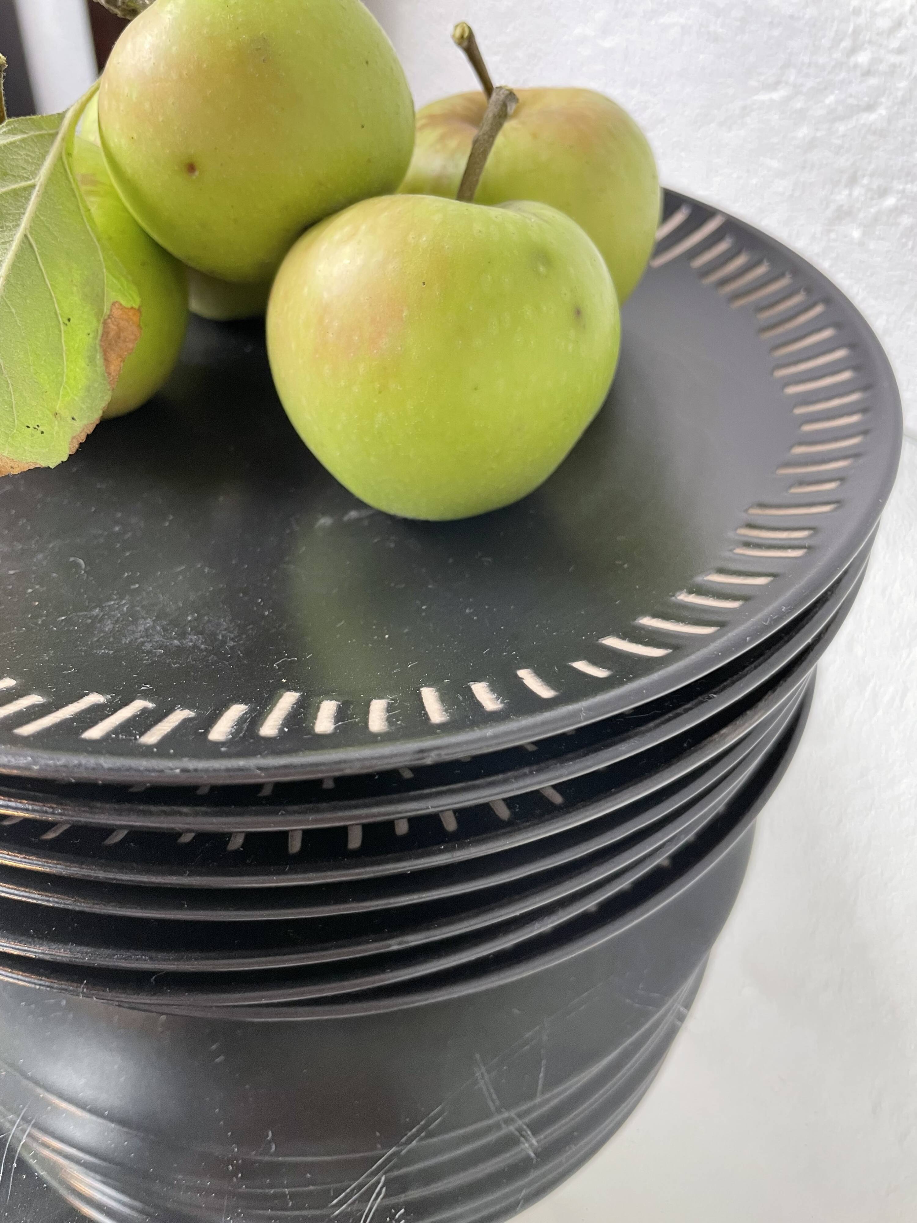 7 black ceramic plates