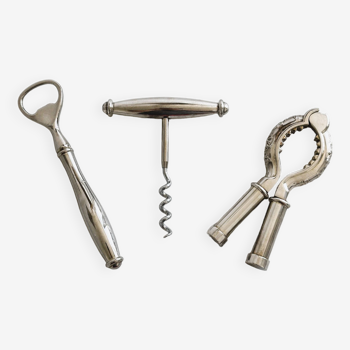 Bottle opener, nutcracker and metal corkscrew.