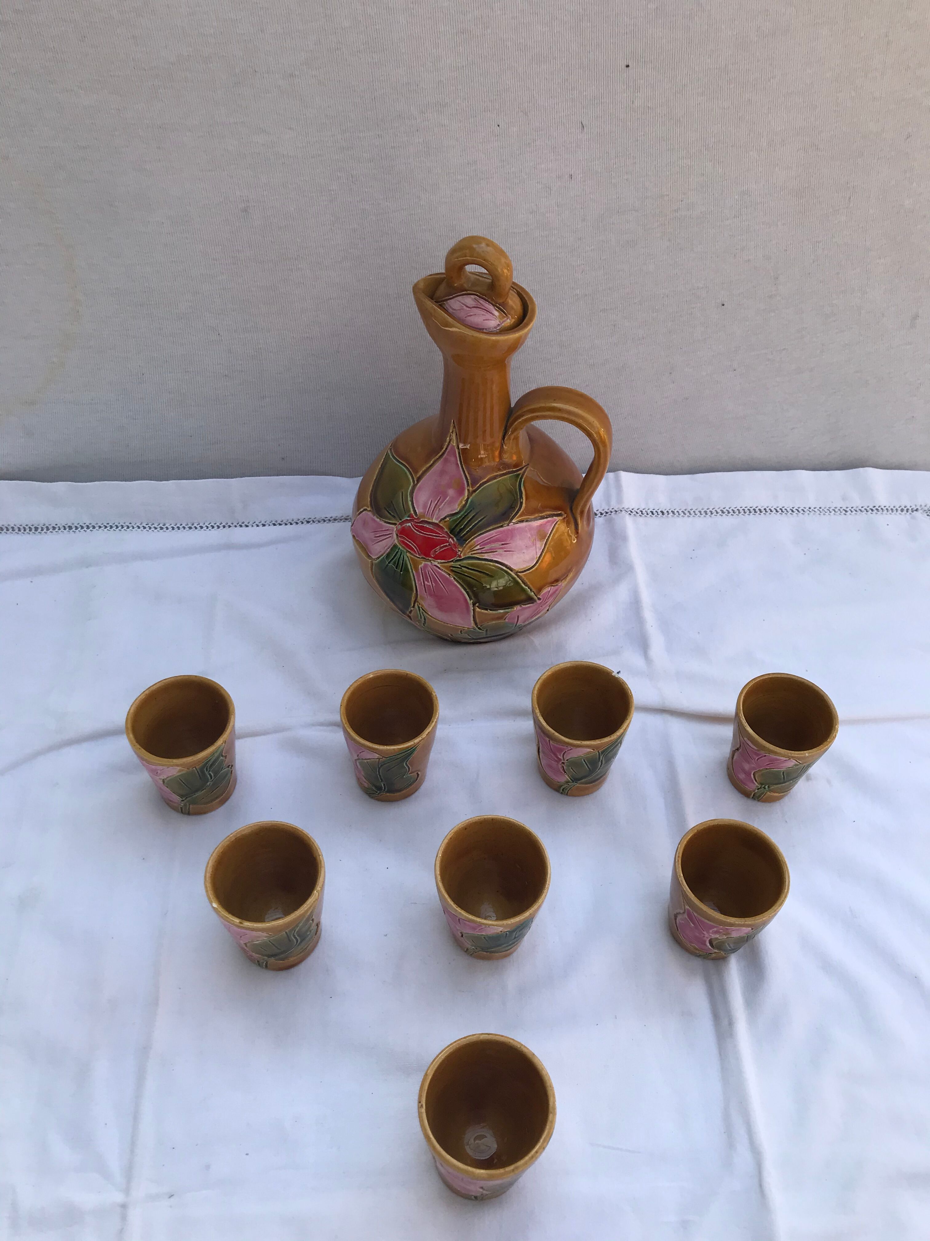 Old carafe with 8 ceramic glasses