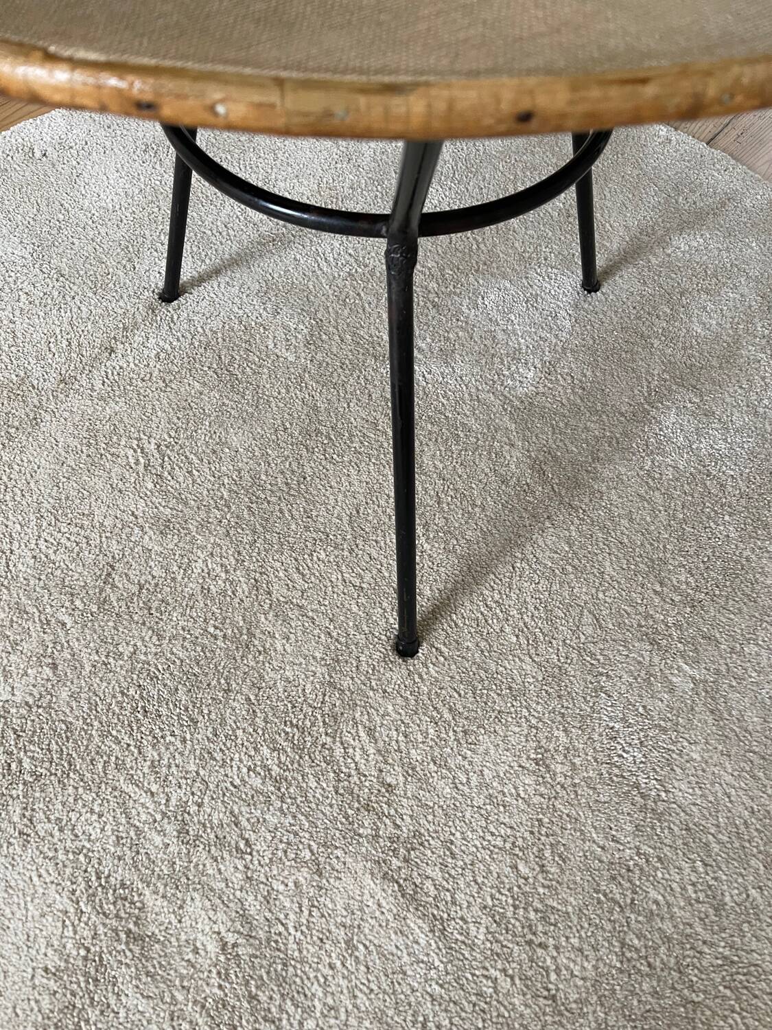 Tripod coffee table with a straw covering.