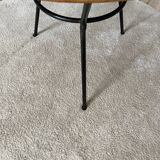 Tripod coffee table with a straw covering.