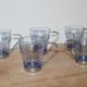 Set of 5 vintage blue-tinted glass cups with metal holders.