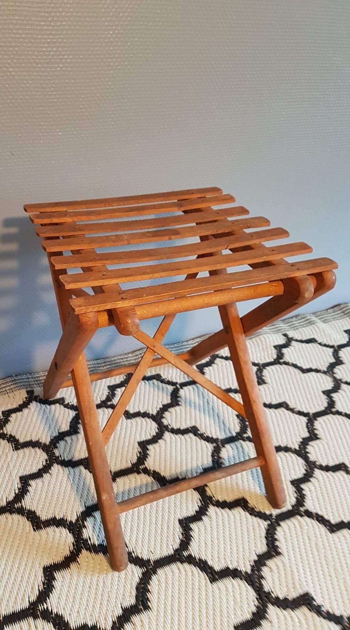 Old foldable stool in tinted wood